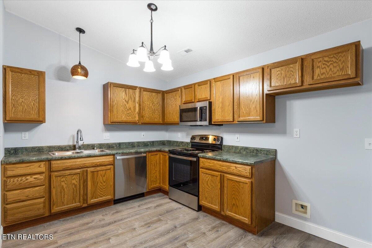 731 High Point Way, Knoxville, TN 37912 - Photo 10 of 25 a kitchen with stainless steel appliances granite countertop wooden cabinets granite counter tops and a hard wood floors