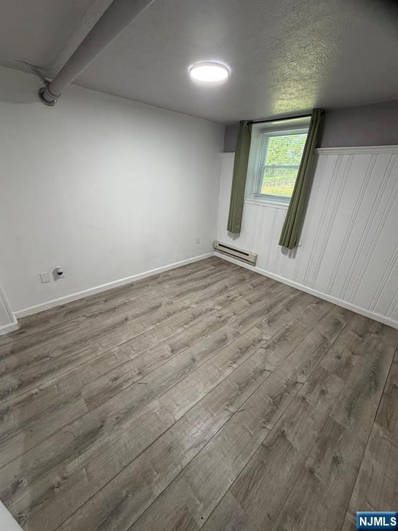 1283 Valley Road, Unit 7 Montclair, NJ 07043 - Photo 8 of 26 an empty room with wooden floor and windows