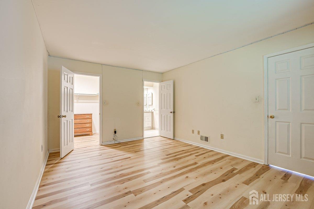 5001 Stonehedge Road Edison, NJ 08820 - Photo 15 of 22 wooden floor in an empty room with a window