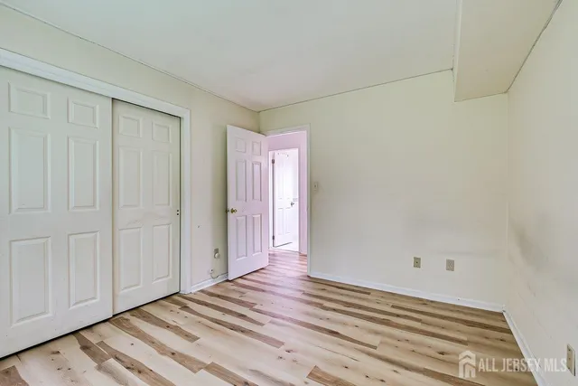 a view of a room with wooden floor and cabinet