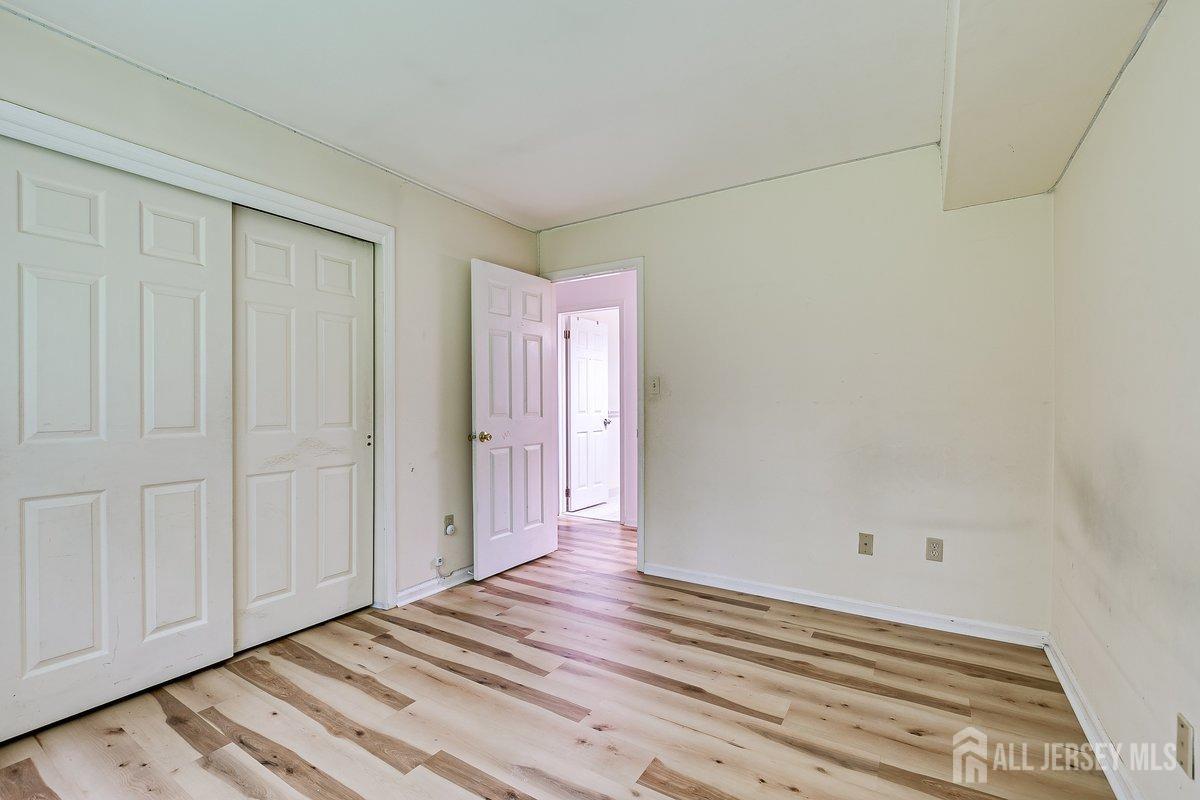 5001 Stonehedge Road Edison, NJ 08820 - Photo 19 of 22 a view of a room with wooden floor and cabinet