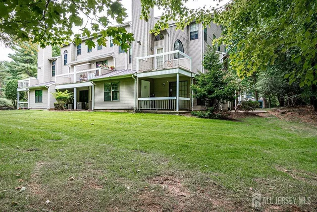 a view of a house with a yard and sitting area
