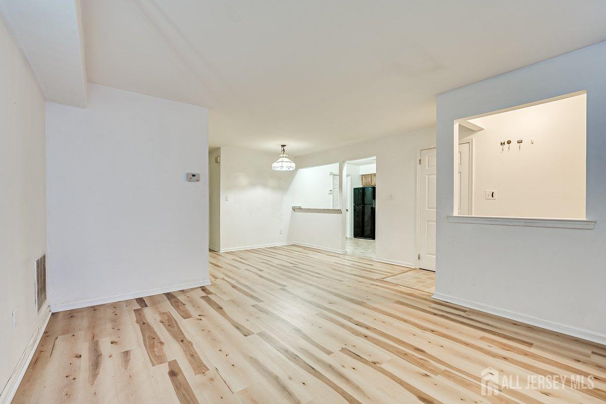 5001 Stonehedge Road Edison, NJ 08820 - Photo 8 of 22 a view of empty room with wooden floor
