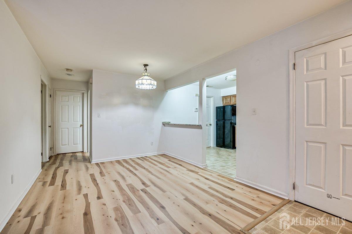5001 Stonehedge Road Edison, NJ 08820 - Photo 9 of 22 wooden floor in a hall with an entryway
