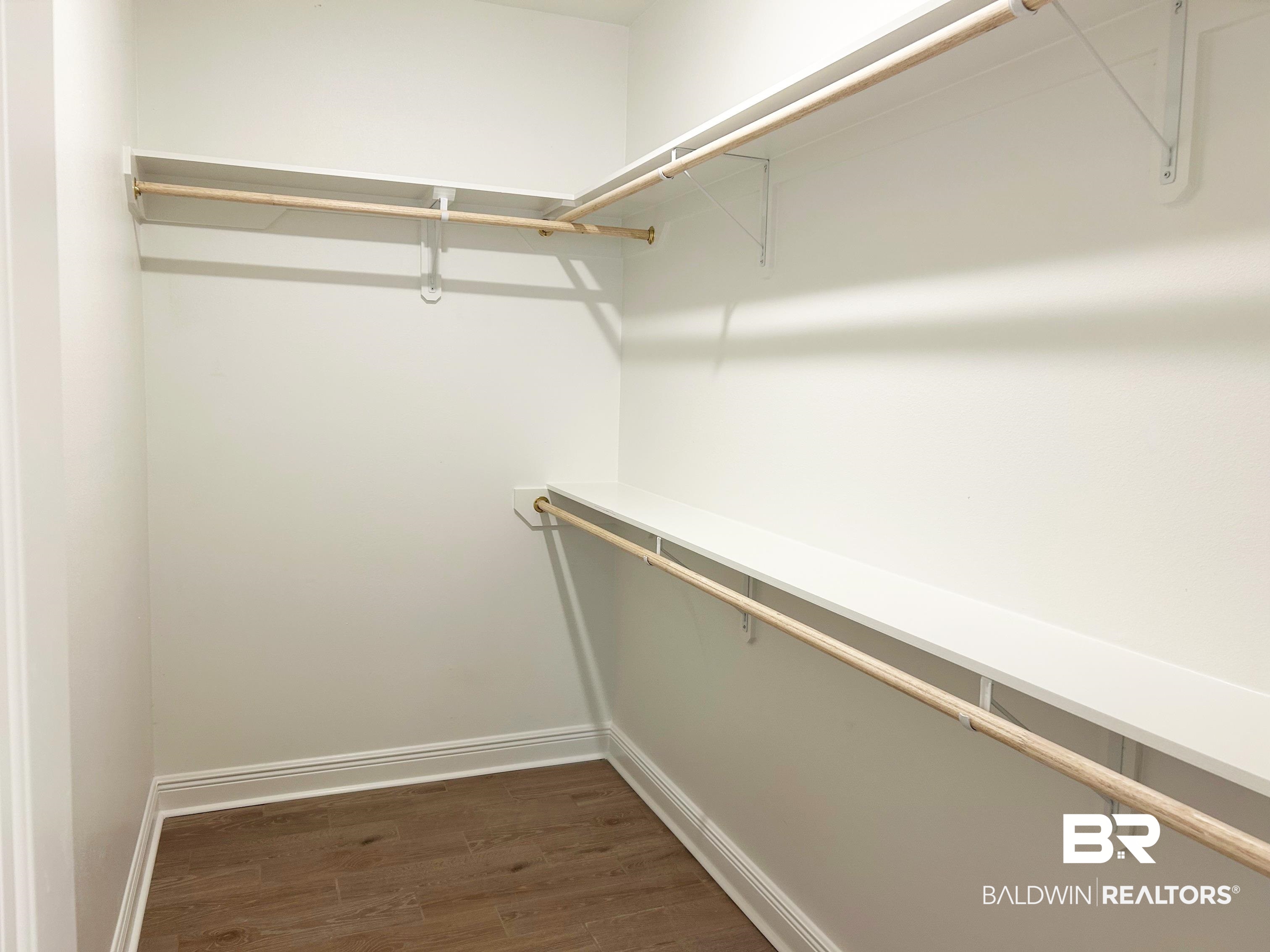 873 Sumter Loop Foley, AL 36535 - Photo 20 of 26 Walk in closet featuring dark wood-style floors