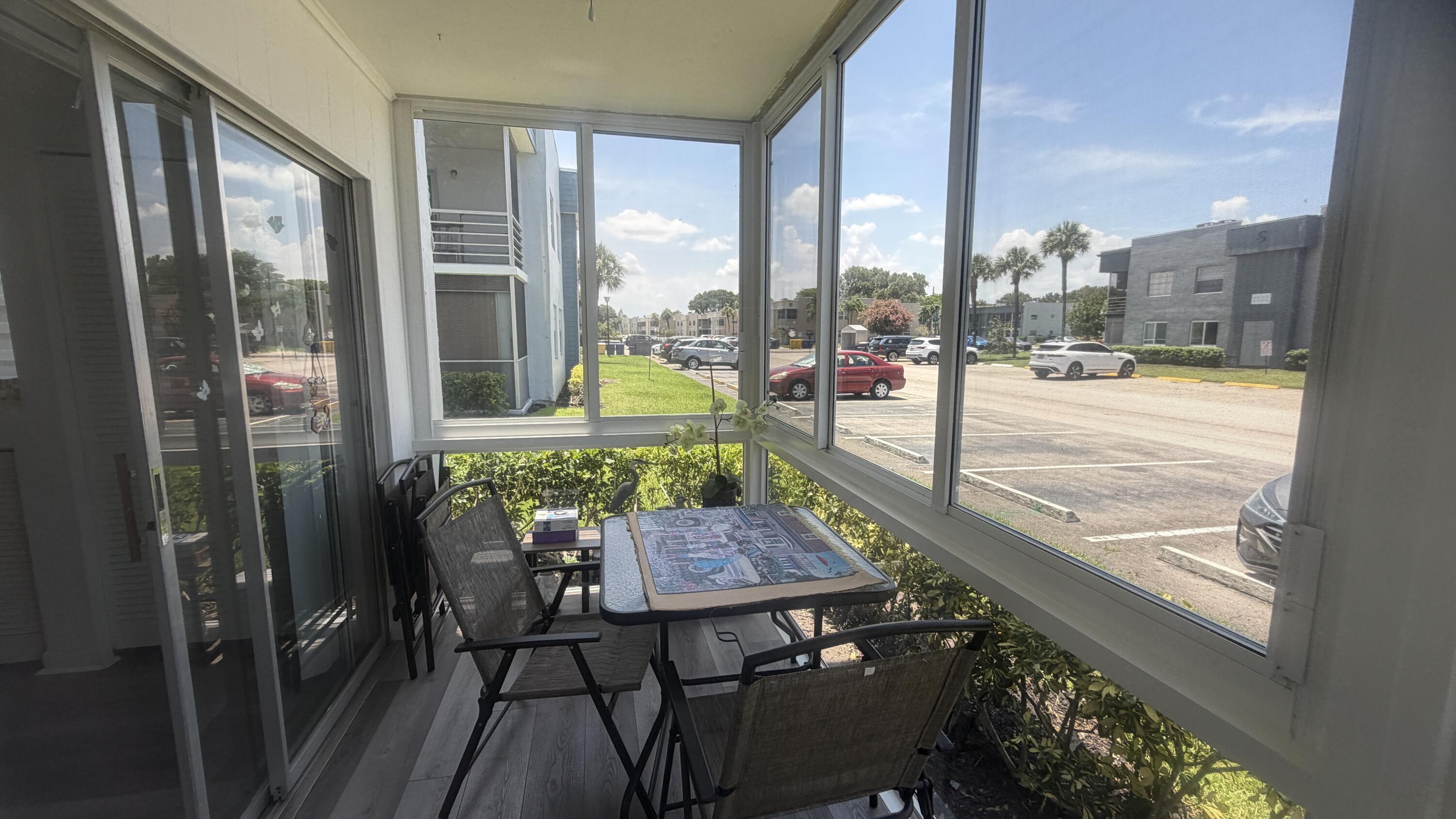 930 Normandy Trail Delray Beach, FL 33484 - Photo 8 of 34 a view of a balcony with lake view and a large window