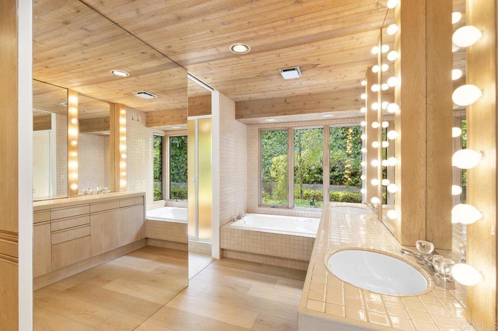 7675 Via Capri La Jolla, CA 92037 - Photo 29 of 75 a bathroom with a tub sink and mirror