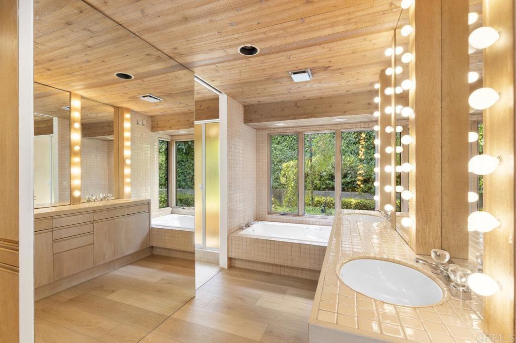 7675 Via Capri La Jolla, CA 92037 - Photo 30 of 75 a bathroom with a tub sink and mirror