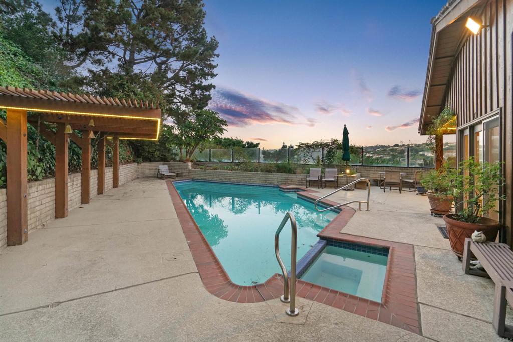 7675 Via Capri La Jolla, CA 92037 - Photo 42 of 75 a view of swimming pool with outdoor seating and plants