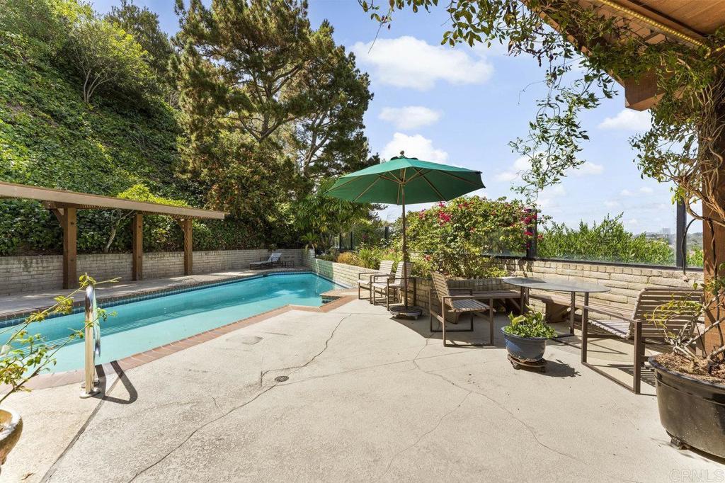 7675 Via Capri La Jolla, CA 92037 - Photo 52 of 75 a view of a patio with a table and chairs under an umbrella