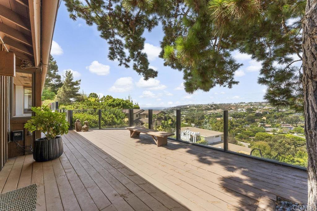 7675 Via Capri La Jolla, CA 92037 - Photo 54 of 75 a view of a terrace with wooden floor and a bench