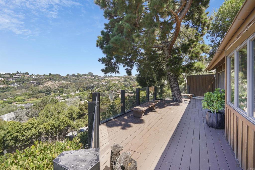 7675 Via Capri La Jolla, CA 92037 - Photo 58 of 75 a view of a patio with couches table and chairs and potted plants