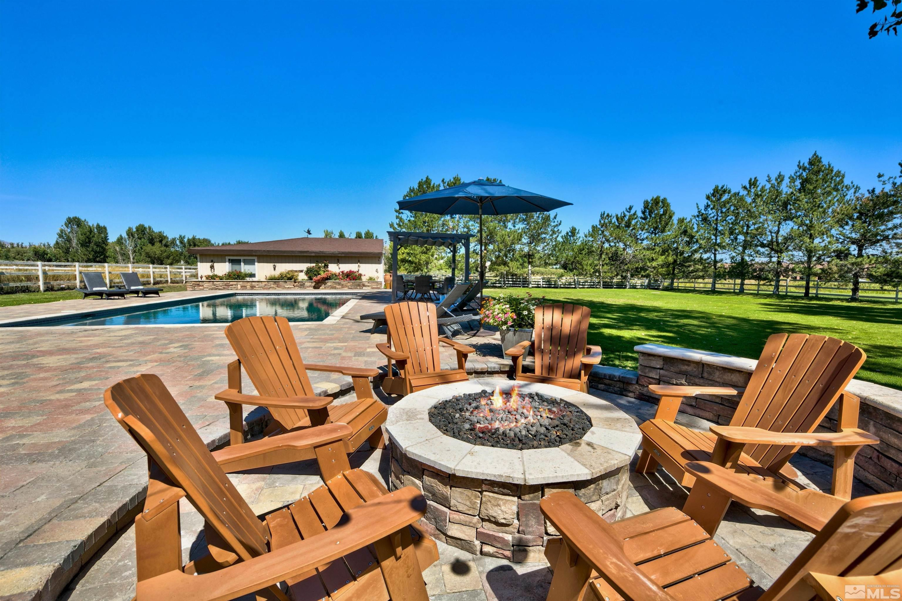 971 Country Estates Circle Reno, NV 89511 - Photo 1 of 40 a view of a chairs and table in patio with a lake view