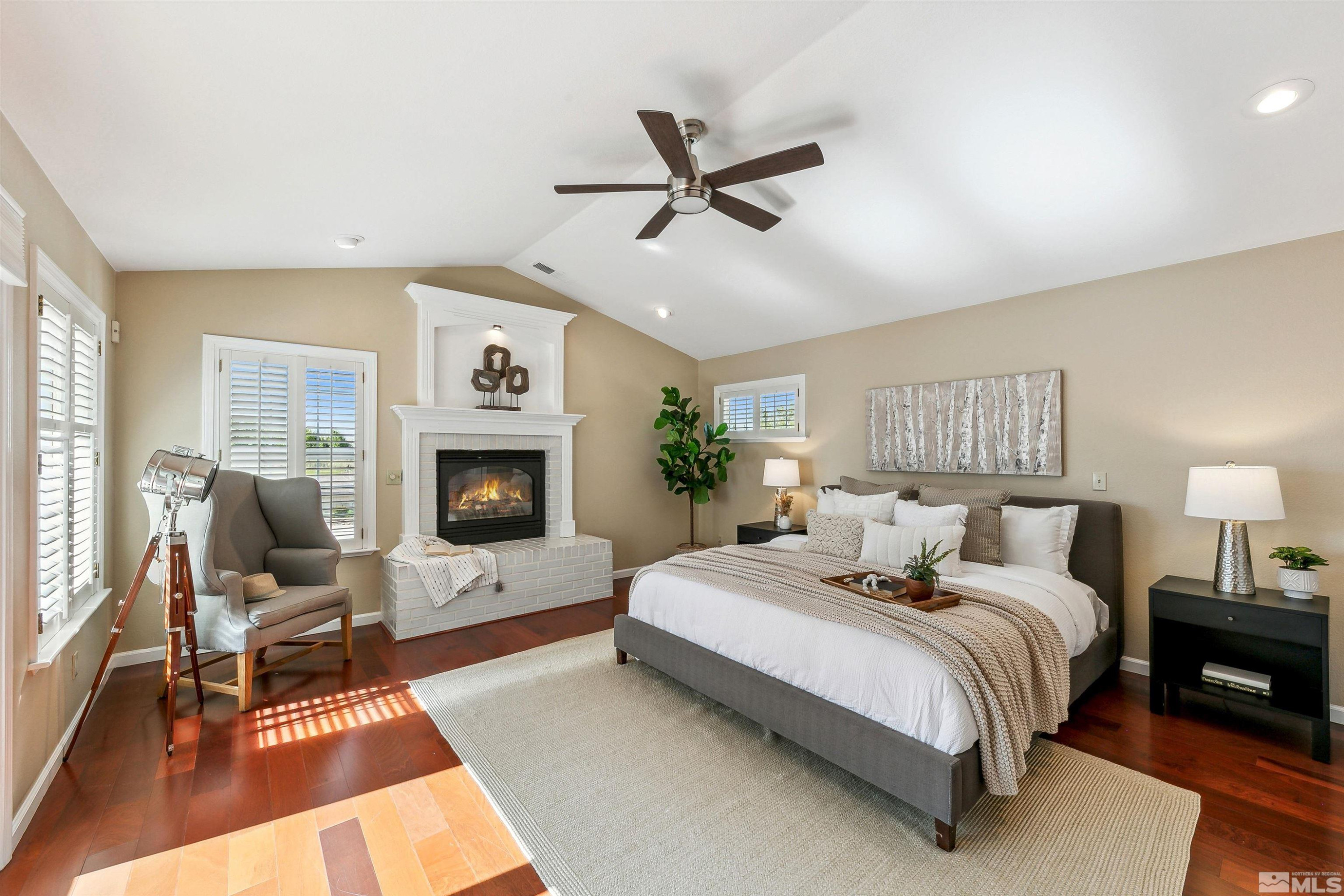 971 Country Estates Circle Reno, NV 89511 - Photo 20 of 40 a bedroom with a large bed and a fireplace