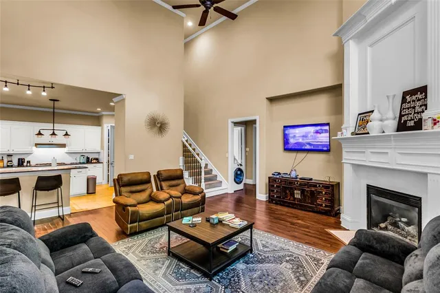 a living room with furniture kitchen view and a fireplace
