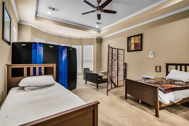 a bedroom with a bed and a chandelier