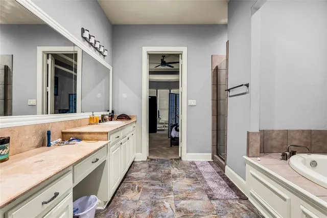 a spacious bathroom with a double vanity sink and a bathtub