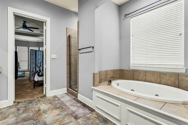 a bathroom with a bathtub and a shower