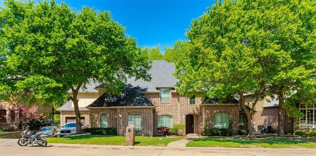 a view of a white house with a yard and plants