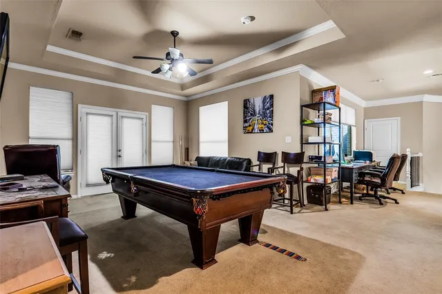 a living room with furniture a dining table and paintings on the wall