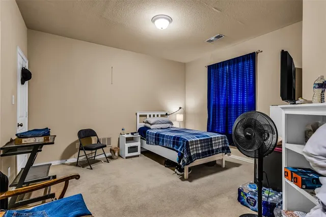 a bedroom with bed and a window