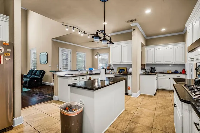 a kitchen with a sink cabinets and appliances