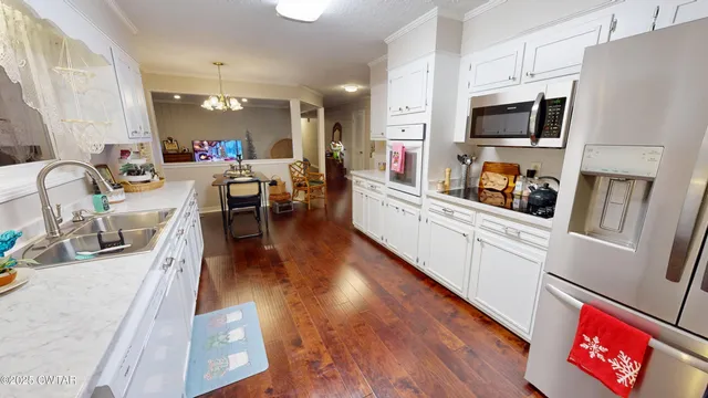 a large white kitchen with lots of counter top space