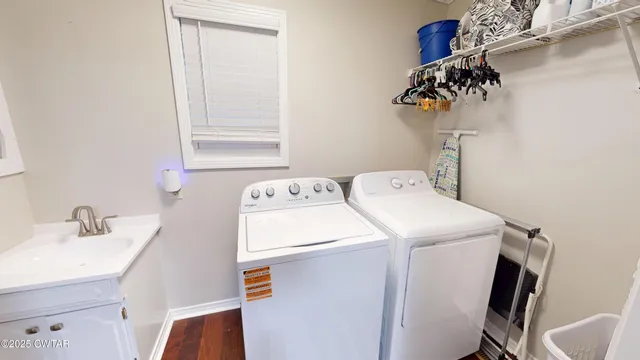 a utility room with sink dryer and washer