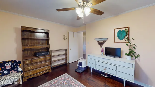 a living room with furniture a window and a flat screen tv