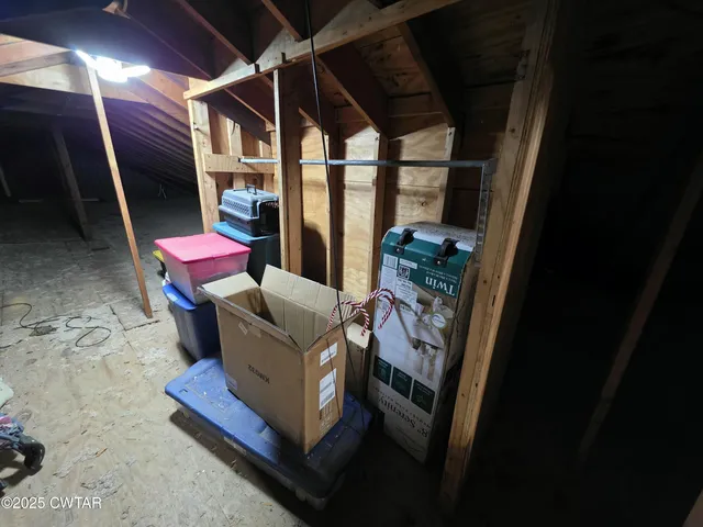 a view of a backyard with table and chairs potted plants