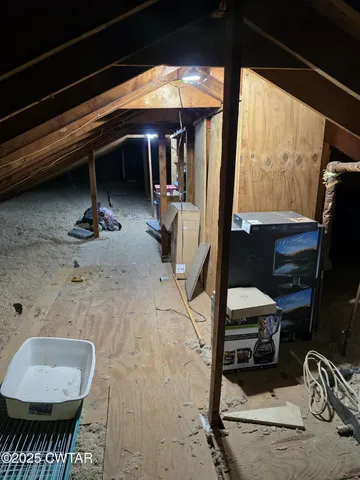 a view of a garage with rack and bicycle