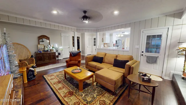 a living room with furniture and wooden floor