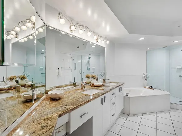 a bathroom with a double vanity sink and a mirror