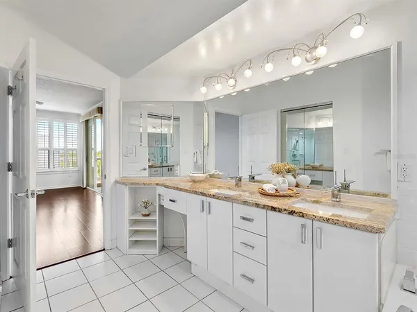 a bathroom with a granite countertop sink a large mirror and vanity