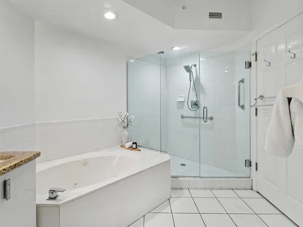 a spacious bathroom with a bathtub and a shower