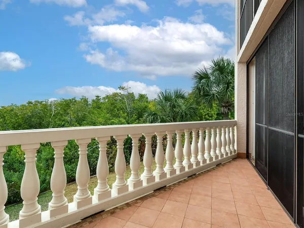 a balcony with wooden floor and fence