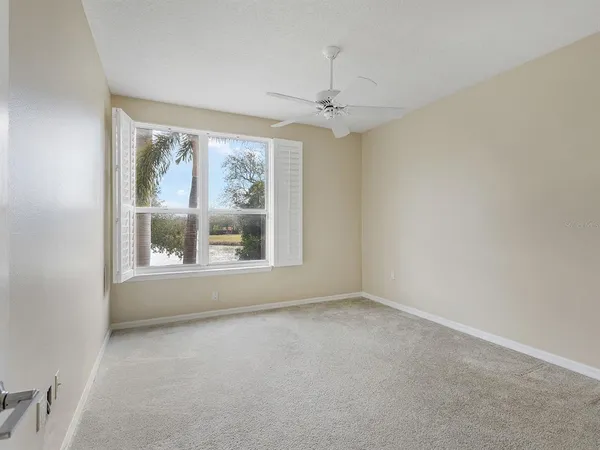 a bedroom with bed and large windows