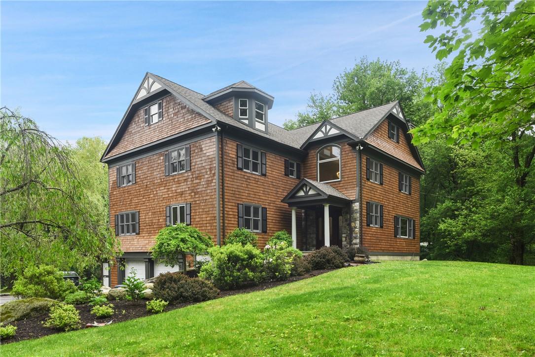 3 Peters Lane Pound Ridge, NY 10576 - Photo 1 of 1 a front view of a house with a garden and plants