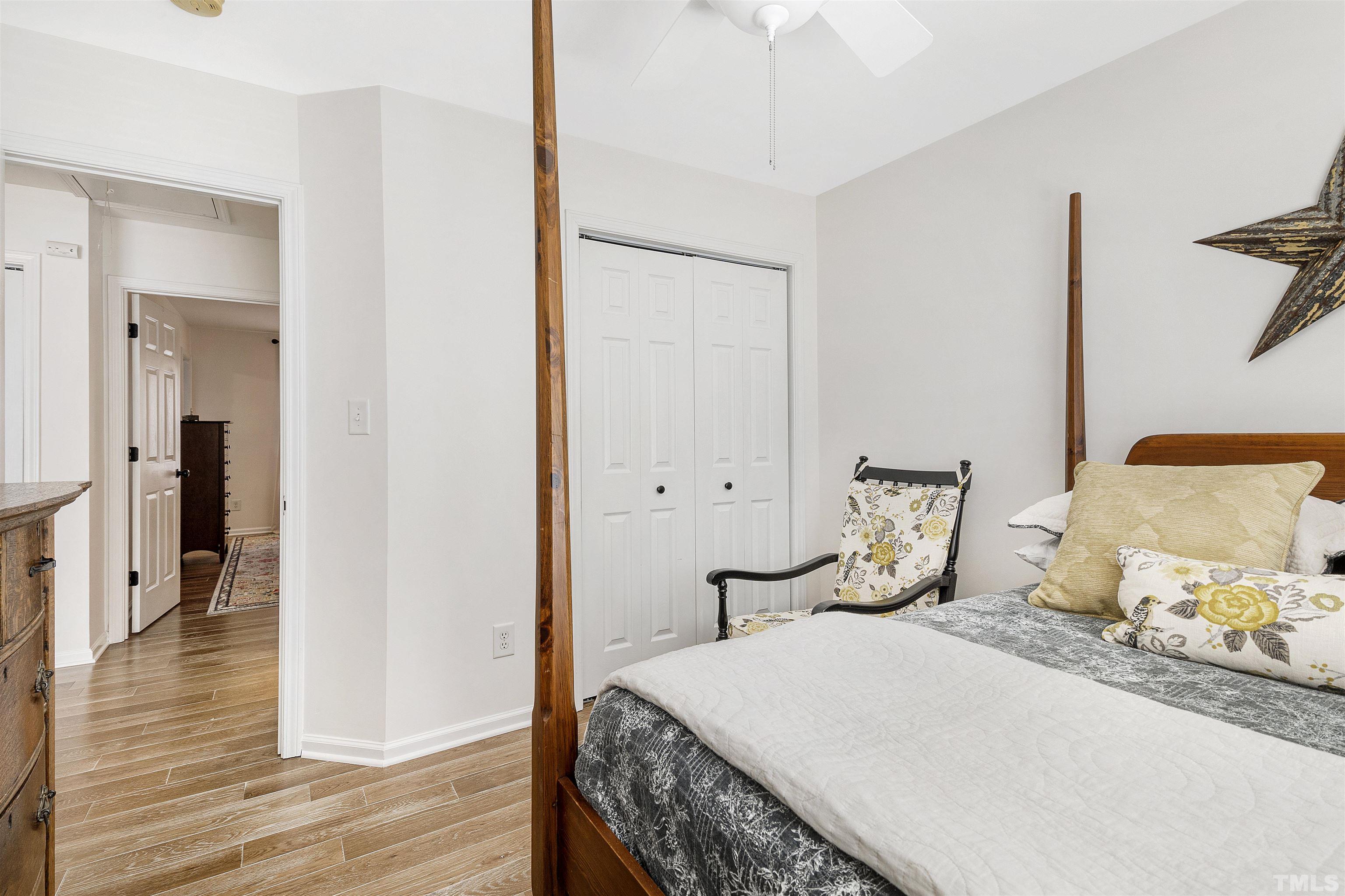 2704 Andover Glen Road Raleigh, NC 27604 - Photo 24 of 30 a bedroom with a bed and wooden floor