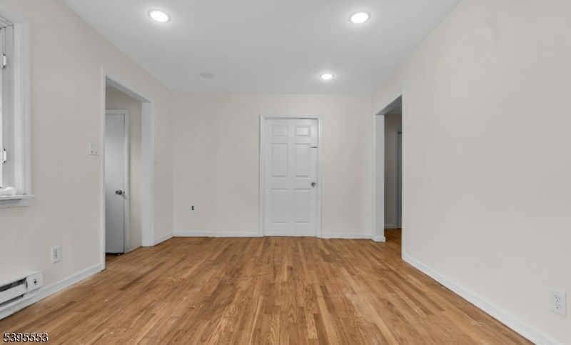 932 Wheatsheaf Road Roselle, NJ 07203 - Photo 11 of 44 a view of a room with wooden floor and white walls