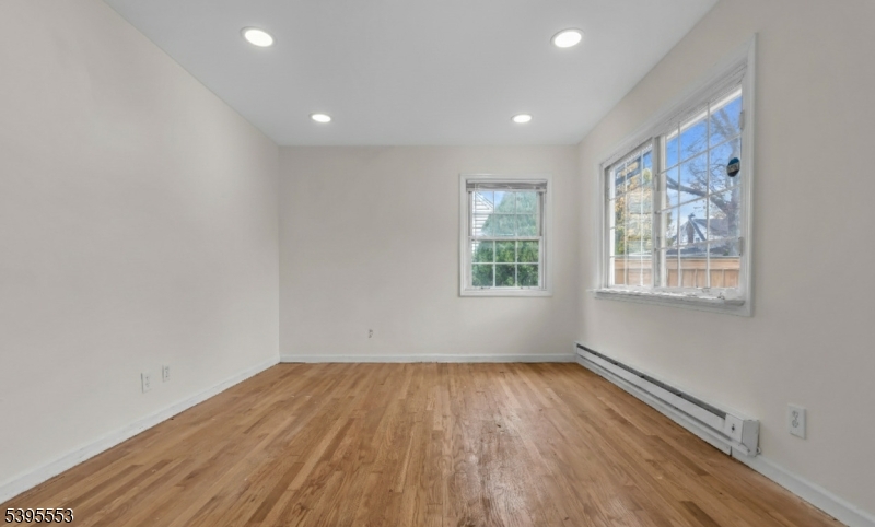 932 Wheatsheaf Road Roselle, NJ 07203 - Photo 15 of 44 a view of empty room with wooden floor and fan
