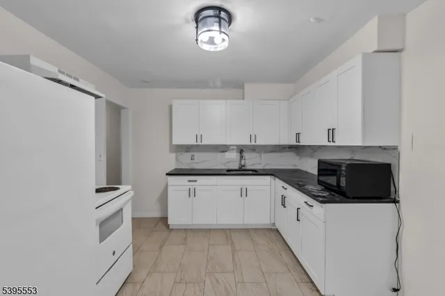 a kitchen with cabinets stainless steel appliances and a counter space