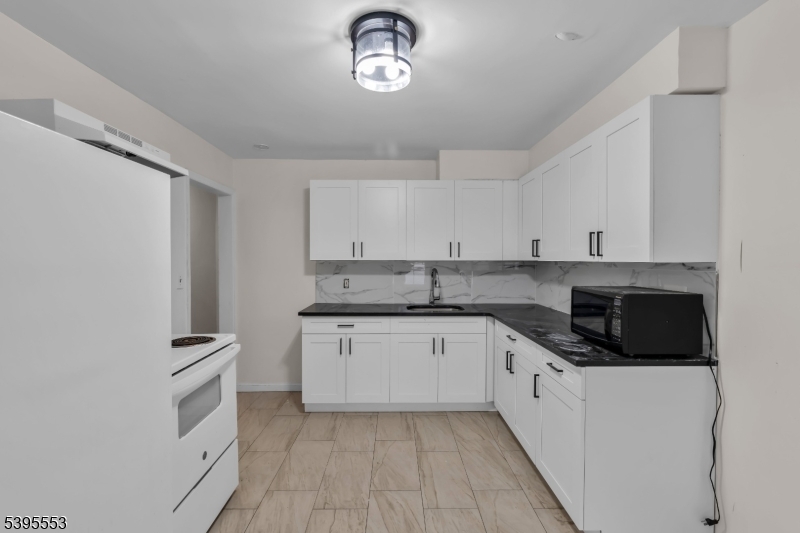 932 Wheatsheaf Road Roselle, NJ 07203 - Photo 17 of 44 a kitchen with cabinets stainless steel appliances and a counter space