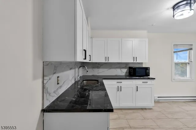 a kitchen with stainless steel appliances a stove a sink and a microwave