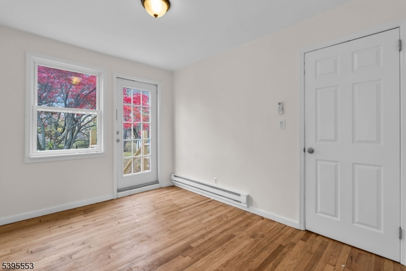 932 Wheatsheaf Road Roselle, NJ 07203 - Photo 21 of 44 a view of an empty room with window and wooden floor