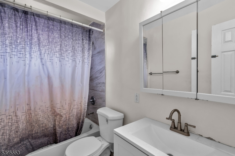 932 Wheatsheaf Road Roselle, NJ 07203 - Photo 24 of 44 a bathroom with a sink a toilet and shower