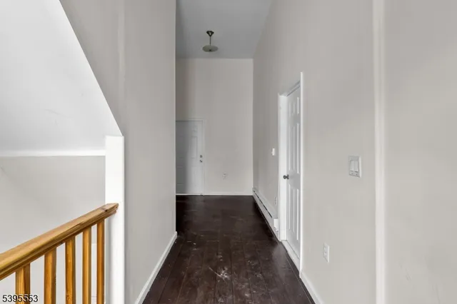 a view of a hallway with a wooden floor