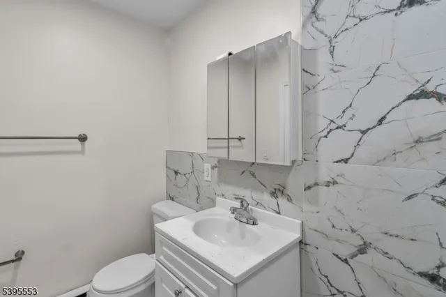 a bathroom with a sink toilet and vanity