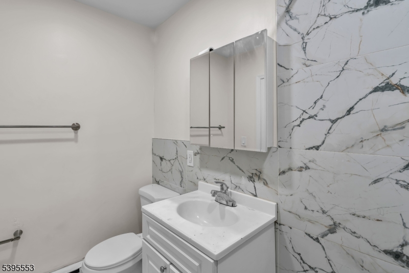 932 Wheatsheaf Road Roselle, NJ 07203 - Photo 28 of 44 a bathroom with a sink toilet and vanity