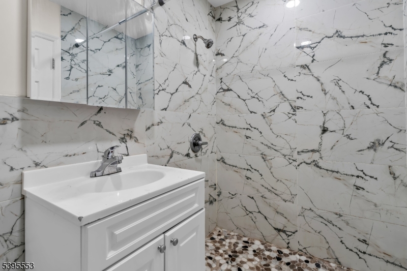 932 Wheatsheaf Road Roselle, NJ 07203 - Photo 29 of 44 a bathroom with a sink and vanity
